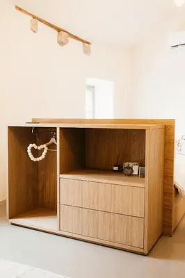 a wooden cabinet in a room with a bed at Grad Štanjel House in Štanjel