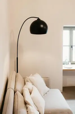 a lamp sitting next to a couch in a living room at Grad Štanjel House in Štanjel