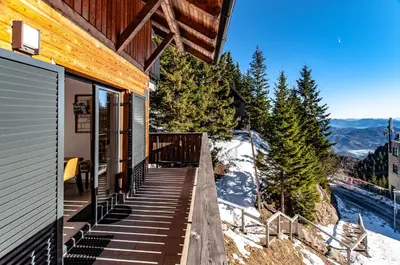 a balcony of a house with a view of the mountains at Apartma Kadulja Golte in Mozirje