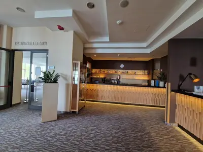 a lobby of a hotel with a counter and a restaurant at Apartma Kadulja Golte in Mozirje