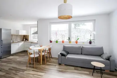 a kitchen and living room with a couch and a table at Central Garden House (family friendly!) in Postojna