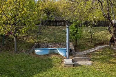 a blue tub sitting on the grass in a yard at Hiška pod Rudnico 1 in Podčetrtek
