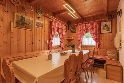 a dining room with a table and chairs in a cabin at Hiška pod Rudnico 1 in Podčetrtek