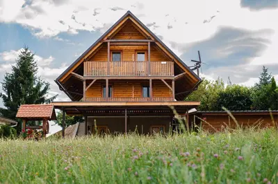 a large wooden house with a porch and a balcony at APARTMA-SPA NATURA in Sveti Jurij ob Ščavnici