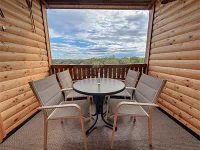 a table and chairs on the balcony of a cabin at APARTMA-SPA NATURA in Sveti Jurij ob Ščavnici