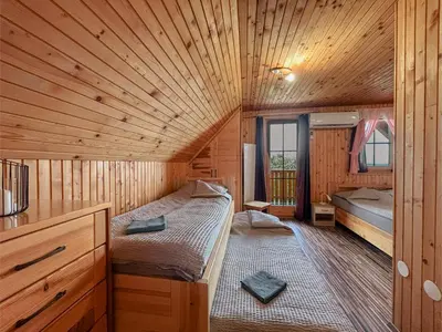 a room with two beds in a wooden cabin at APARTMA-SPA NATURA in Sveti Jurij ob Ščavnici