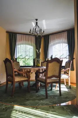 a dining room with a wooden table and chairs at Apartmaji Krebs in Mežica