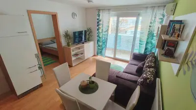 a living room with a couch and a table at Apartma Knap Velenje in Velenje