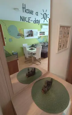 a room with a table and two shoes on the floor at Apartma Knap Velenje in Velenje