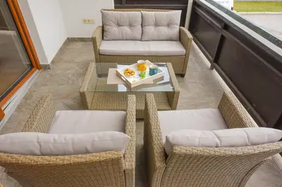 a balcony with chairs and a table with a plate of food at Holiday Home Toplica Natura with natural thermal Bath in Cerklje ob Krki