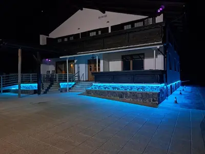 a building with blue lights on it at night at Holiday Home Toplica Natura with natural thermal Bath in Cerklje ob Krki