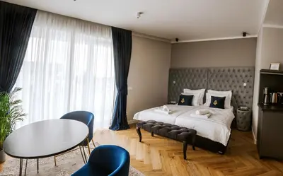 a bedroom with a bed and a table and chairs at Bresidence Apartments with free private parking in Ljubljana
