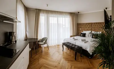 a hotel room with a bed and a table at Bresidence Apartments with free private parking in Ljubljana