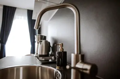 a kitchen sink with a faucet next to a sink at Bresidence Apartments with free private parking in Ljubljana