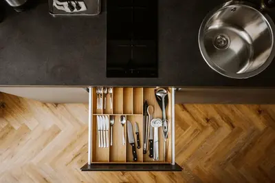 a kitchen drawer filled with utensils under a counter at Bresidence Apartments with free private parking in Ljubljana