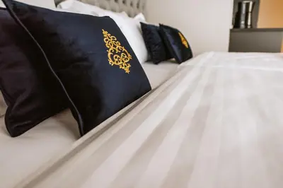a bed with black and gold pillows on it at Bresidence Apartments with free private parking in Ljubljana