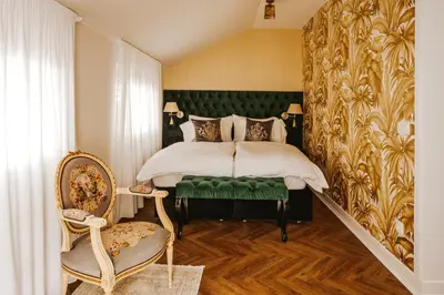 a bedroom with a bed with a green headboard at Bresidence Apartments with free private parking in Ljubljana