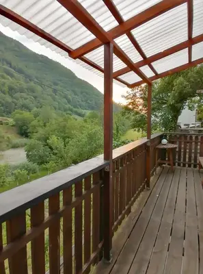 a deck with a view of the mountains at počitniška hiška MEDVEJKE in Slappe dʼIdria