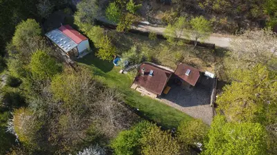 an overhead view of a house and a truck in a field at Hiška pod Rudnico 2 in Podčetrtek