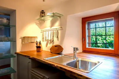 a kitchen with a sink and a window at Karst house Žan Pliskovica with private pool in Dutovlje