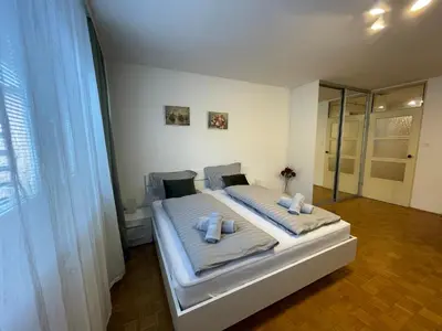 a bedroom with a bed with two pillows on it at Apartment Green - Grey in Ljubljana