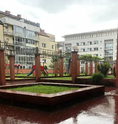 a park with a playground in front of some buildings at Apartment Green - Grey in Ljubljana