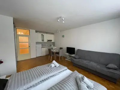 a living room with a couch and a table at Apartment Green - Grey in Ljubljana