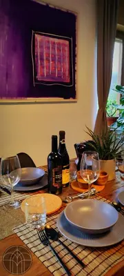 a wooden table with plates and wine glasses on it at Moksha Slovenia in Tolmin