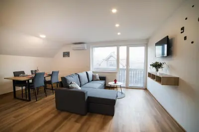a living room with a couch and a table at Apartma Lida 2 in Bled