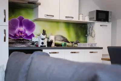 a kitchen with a purple flower on the wall at Apartma Lida 2 in Bled
