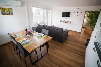 a living room with a table and a couch at Apartma Lida 1- mirna lokacija, brezplačno parkirišče, 10 minut hoje do jezera in gradu in Bled