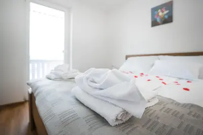 a bed with towels sitting on top of it at Apartma Lida 1- mirna lokacija, brezplačno parkirišče, 10 minut hoje do jezera in gradu in Bled