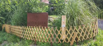 a wooden fence with a sign that says woksha at Retro in Tolmin