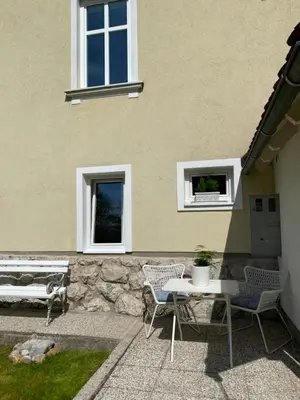 a patio with two chairs and a table and a bench at Historical Villa in the heart of Bled 2 in Bled