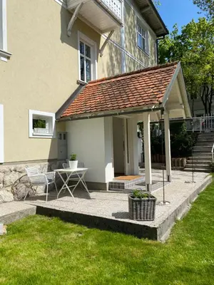 a patio with a table and a roof at Historical Villa in the heart of Bled 2 in Bled