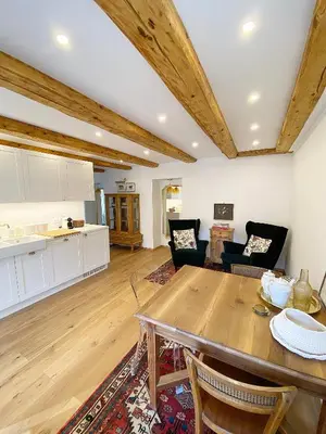 a living room with a table and a kitchen at Historical Villa in the heart of Bled 2 in Bled