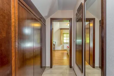 a hallway with two doors and a room with a hallway at Pool Villa Silva Marija Apartments in Pišece