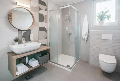 a bathroom with a sink and a shower and a toilet at B&B Pod vrbo in Ljubljana