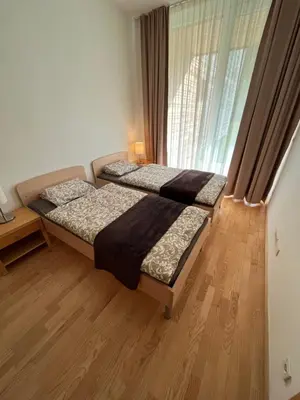 a bedroom with two beds and a window at Golden Fox Apartment Pohorje in Maribor