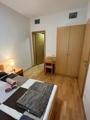 a bedroom with a bed and a desk and a table at Golden Fox Apartment Pohorje in Maribor