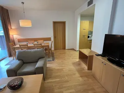 a living room with a couch and a television at Golden Fox Apartment Pohorje in Maribor