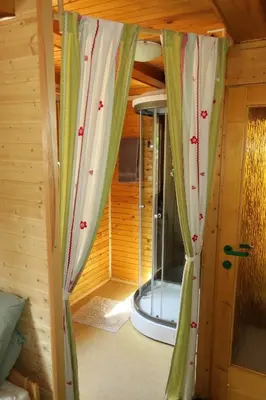 a room with curtains in a tiny house at ARIA in Sviščaki