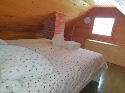 a bedroom with a bed in a attic at ARIA in Sviščaki