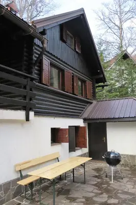a building with a picnic table and a grill at ARIA in Sviščaki
