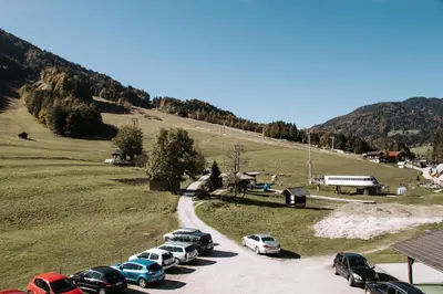 a group of cars parked in a parking lot at Apartma Sonček, on the ski slopes, balcony, private parking in Kranjska Gora