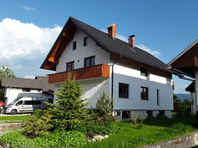 a white house with a black roof at Hiša Višnar in Bled