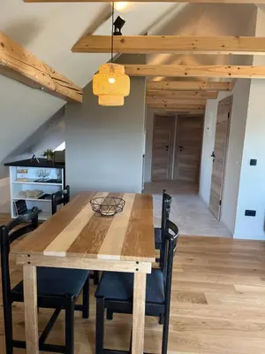 a dining room with a wooden table and chairs at Hiša Višnar in Bled
