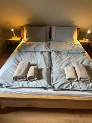 a large bed with two pillows on it at Hiša Višnar in Bled