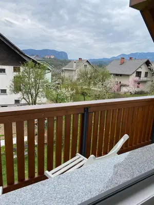 a table and chairs on a balcony with a view at Hiša Višnar in Bled