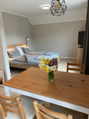 a dining room table with a vase of flowers on it at Hiša Višnar in Bled